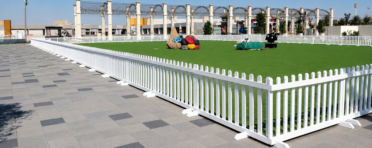 White PVC picket fencing on a lawn